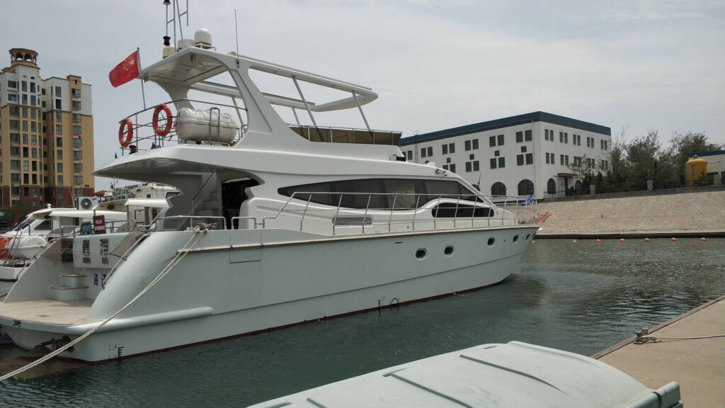 Fiberglass composite boat docked at marina, highlighting modern boat building material advantages.