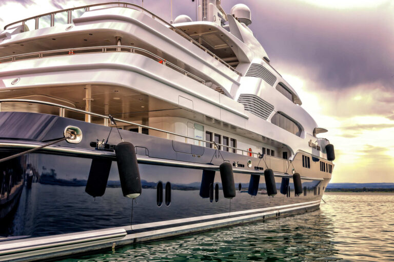 Fiberglass luxury yacht docked at marina, demonstrating the advantages of composite boat building materials.