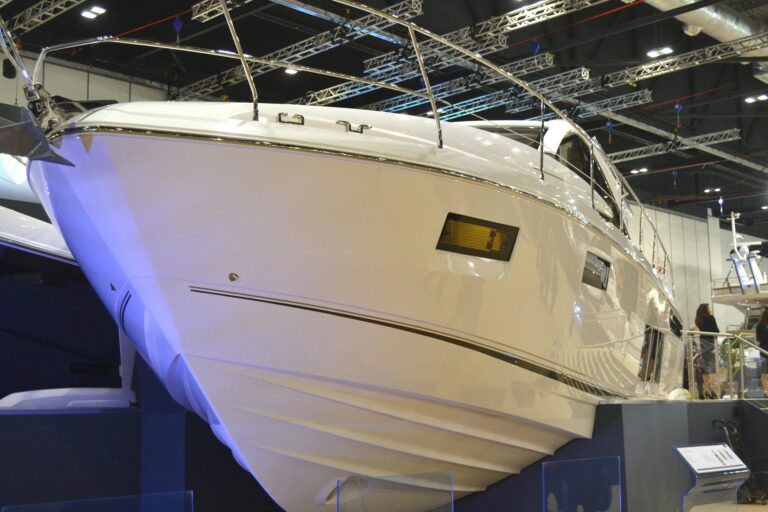 Close-up of championship hard chine boat hull at marine exhibition, highlighting angular chine structure cutting through water