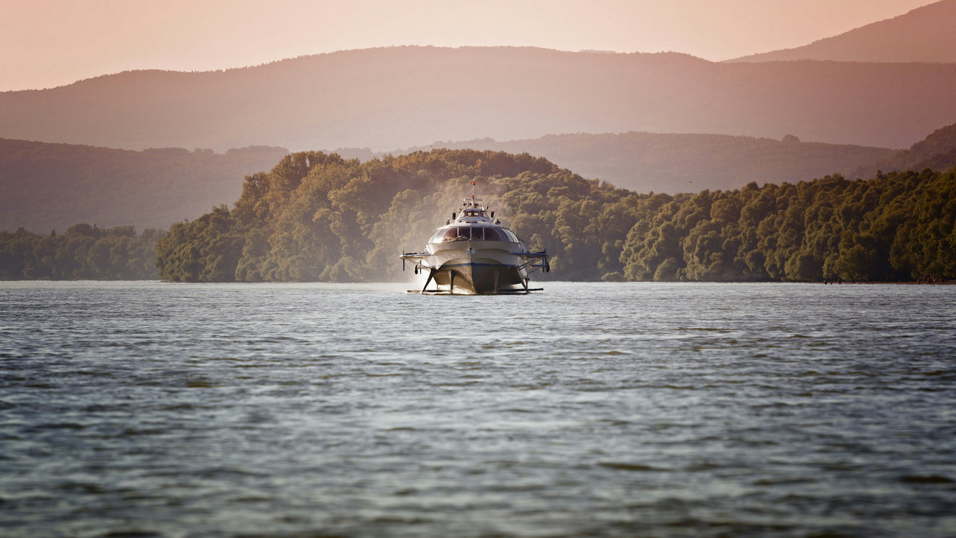 Front view of a hydrofoil boat’s bow gliding across a wide open sea
