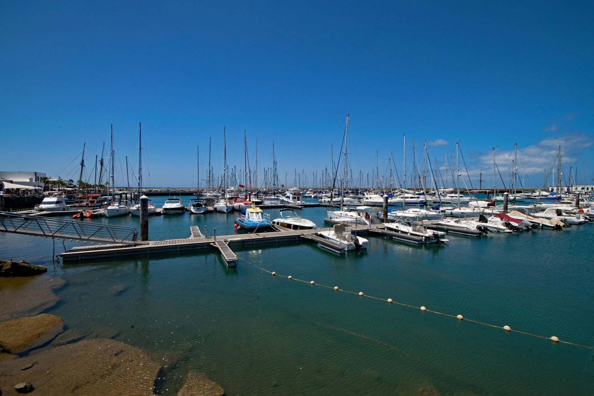Modern marina with aluminum and fiberglass boats docked side by side