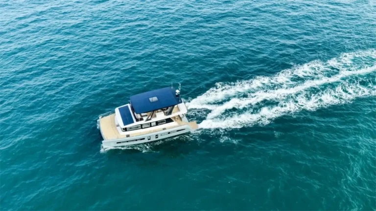 Aerial photo capturing an electric recreational boat operating with zero pollution on blue water.